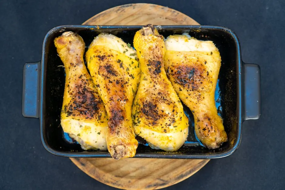 Delicious baked chicken drumsticks perfectly cooked in a pan.