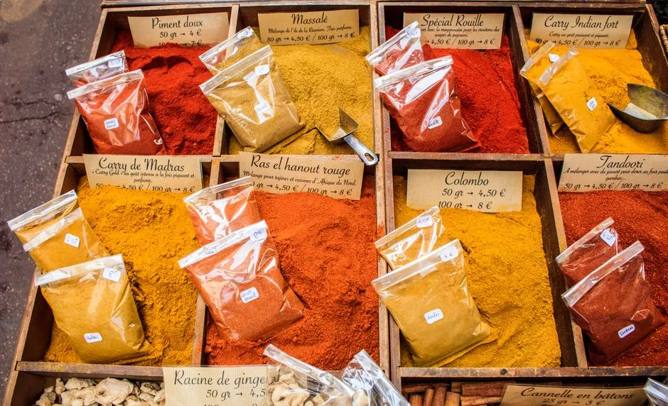 Vibrant spices displayed at a local market in Nice, France, showcasing diverse colors and flavors.