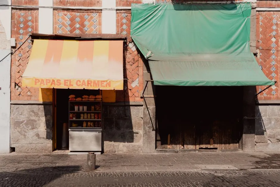 Vibrant awning with a snack display in Puebla, Mexico. Sunlit street scene.