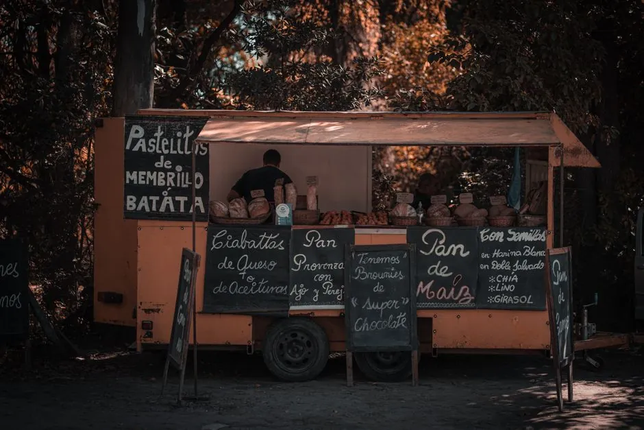 A nostalgic street food stall selling assorted breads in an autumn setting.