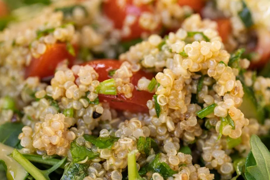Vibrant quinoa salad with cherry tomatoes, greens, perfect for healthy eating.