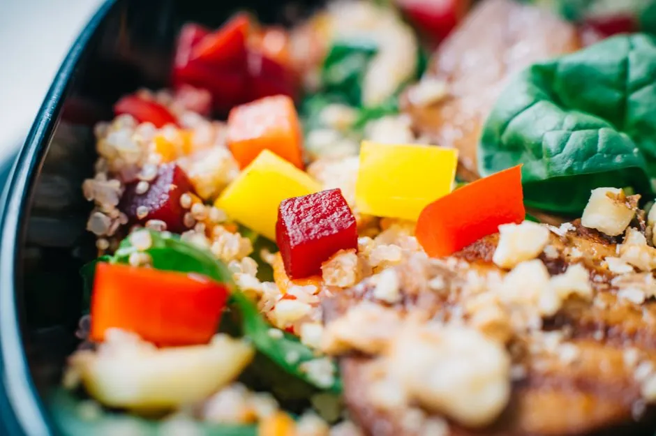 Vibrant quinoa salad featuring spinach, bell peppers, and feta cheese.