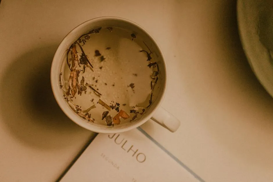A warm cup of herbal tea resting on a July calendar page, perfect for a cozy day.