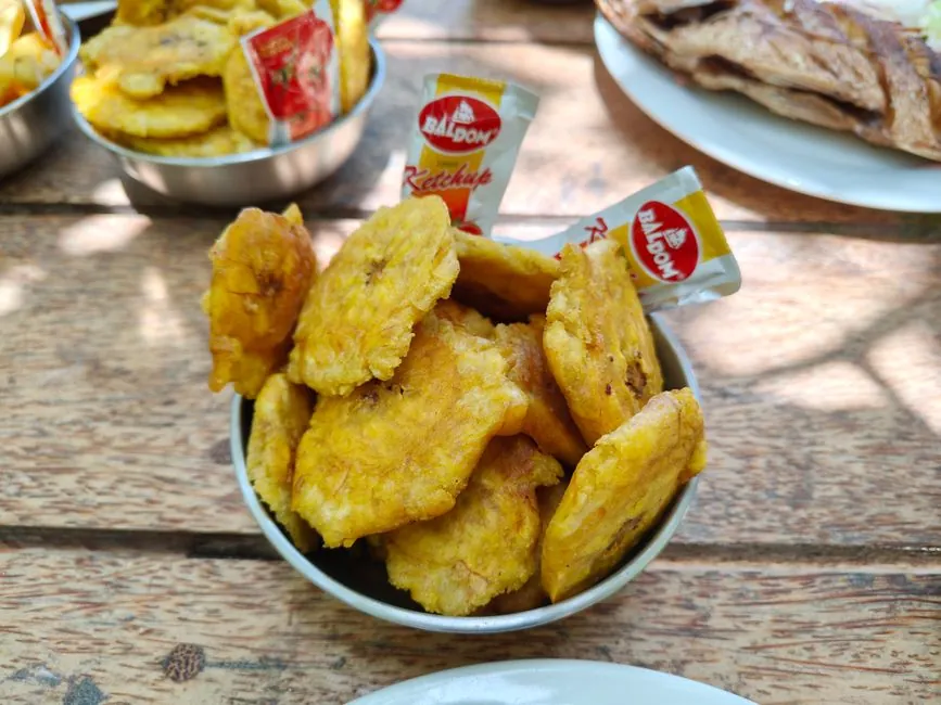 Crispy fried plantain chips served with Baldom ketchup in Samaná, Dominican Republic.
