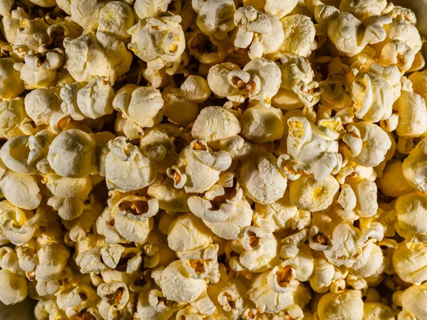 A vibrant close-up of freshly popped, golden popcorn, perfect for movie nights.
