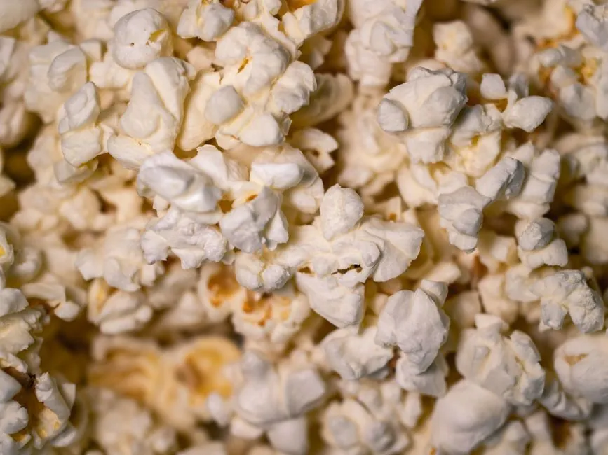 Detailed close-up of freshly popped buttery popcorn, perfect as a snack wallpaper.