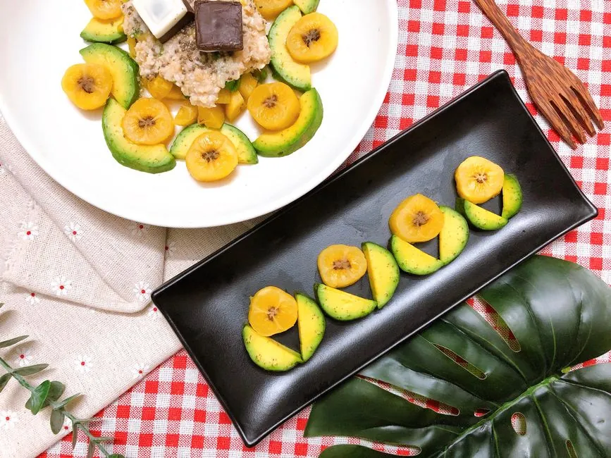 Delicious tropical dessert featuring fresh bananas, avocado, and chocolate on a decorative table setting.