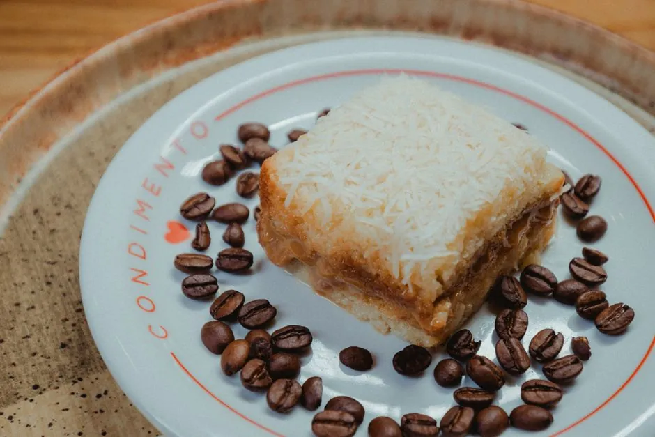 Close-up of a white cake decorated with coffee beans on a stylish plate.