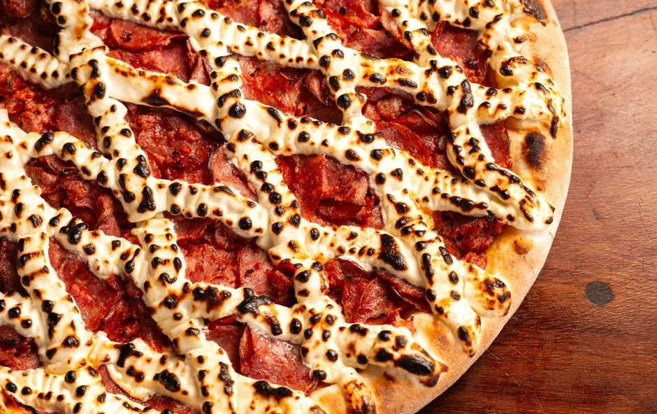 Close-up of a pepperoni pizza with melted cheese, perfect for food enthusiasts.