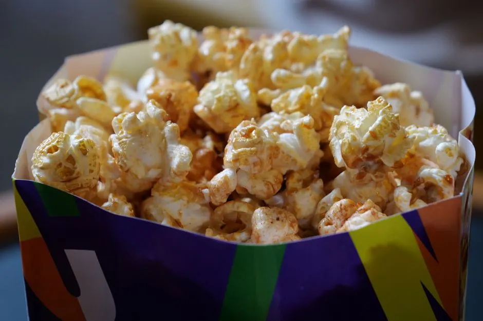 Close-up of crunchy popcorn in a vibrant box, perfect for snack time.